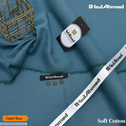 Cadet Blue soft cotton fabric by Gul Ahmed, draped elegantly with a frayed edge, accompanied by a branded paper tag, a white branded ribbon, and decorative buttons, set against a clean white background with a gold wire basket prop. Change water mark into HMA57300000555LSEEGISE